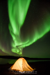 Aurora over lit tent